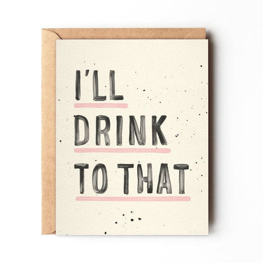 The “I’ll Drink To That” greeting card by Daydream Prints features bold black lettering with pink lines under “DRINK” and “THAT,” making it a fun congratulations card, shown atop a brown envelope.