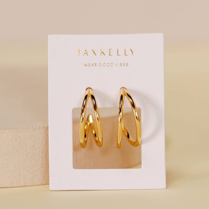 The Illusion Double Hoop by JaxKelly features 18k gold-plated hoops displayed on a white card with "Wear Good Vibes" in gold text.
