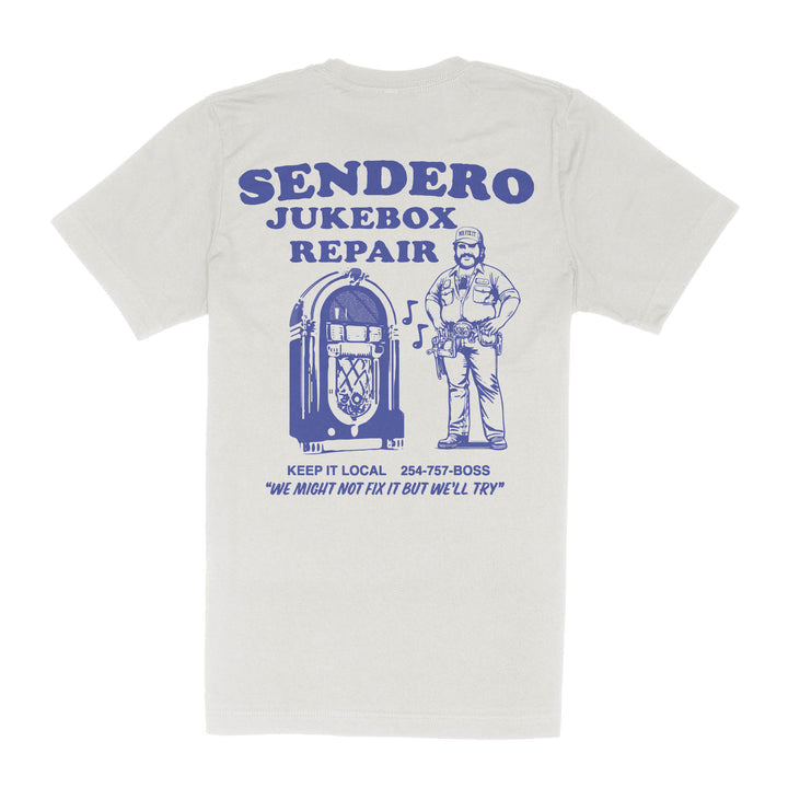 The Jukebox Repair T-Shirt by Sendero Provisions Co. is a white cotton-poly tee with blue jukebox repair graphics and “Sendero Jukebox Repair. Keep it local. 254-757-BOSS.” Soft touch screen print for comfort.