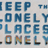 Bold blue text on a textured white background reads, “KEEP THE LONELY PLACES LONELY.” Landscape-colored shading captures the essence of Matt Tumlinson’s art in this striking Giclee print: Keep the lonely Places Lonely by Matt Tumlinson.