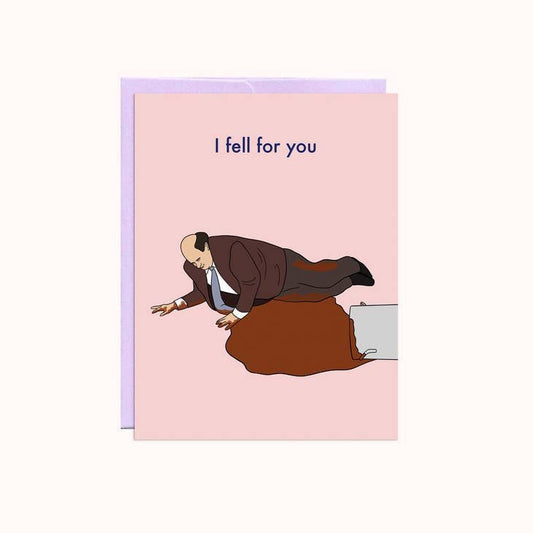 Illustration of a man in a suit slipping into spilled brown liquid with "I fell for you" above. The A2 Kevin Fell For You Valentine's Card by Party Mountain Paper co. is a playful blank greeting card, made in Canada.