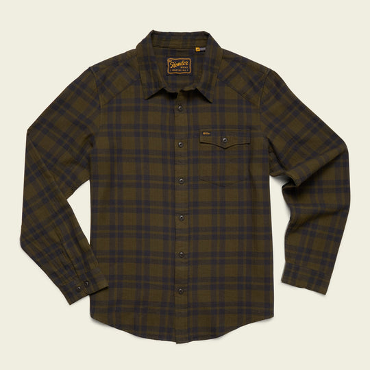 The Howler Brothers La Grange Lightweight Flannel is a green and brown western-inspired long-sleeve shirt with a flap chest pocket and collar, crafted from lightweight flannel for comfort, shown on a light flat background.