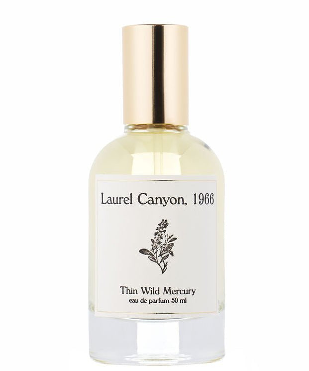 A clear glass bottle with a gold cap, labeled "Laurel Canyon | Thin Wild Mercury" by Thin Wild Mercury, features a black botanical illustration, evoking patchouli notes and the woody essence of canyon air.