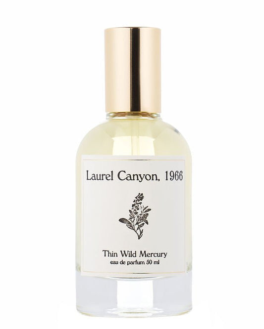 A clear glass perfume bottle with gold cap, labeled "Laurel Canyon | Thin Wild Mercury" by Thin Wild Mercury, 50ml eau de parfum, features a small botanical illustration and captures the scent of woody canyon air and acoustic guitar echoes.