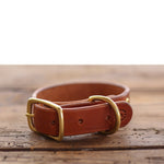 The Leather Dog Collar by Ballad of the Bird Dog features brown leather in classic English bridle style, complete with a brass buckle and D-ring—perfect for pets in Brenham.