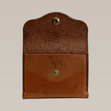 The Handcrafted Leather Wallet - Small Card Holder by Ballad of the Bird Dog features a brown leather design with a snap button and embossed dog outline, showcasing its artisanal quality when opened to reveal the interior.