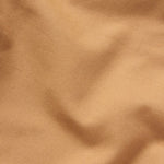 Close-up of Duck Camp Lightweight Brush Pants in light brown, featuring durable cotton blend fabric with visible texture and slight folds.