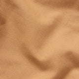 Close-up of Duck Camp Lightweight Brush Pants in light brown, featuring durable cotton blend fabric with visible texture and slight folds.