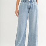 A person wearing JBD's Lightweight Drapey Relaxed Trouser in light blue and a pale yellow sleeveless top stands against a plain background.