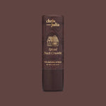 A tube of Poppy & Pout Lip Balm is shown upright against a brown background.