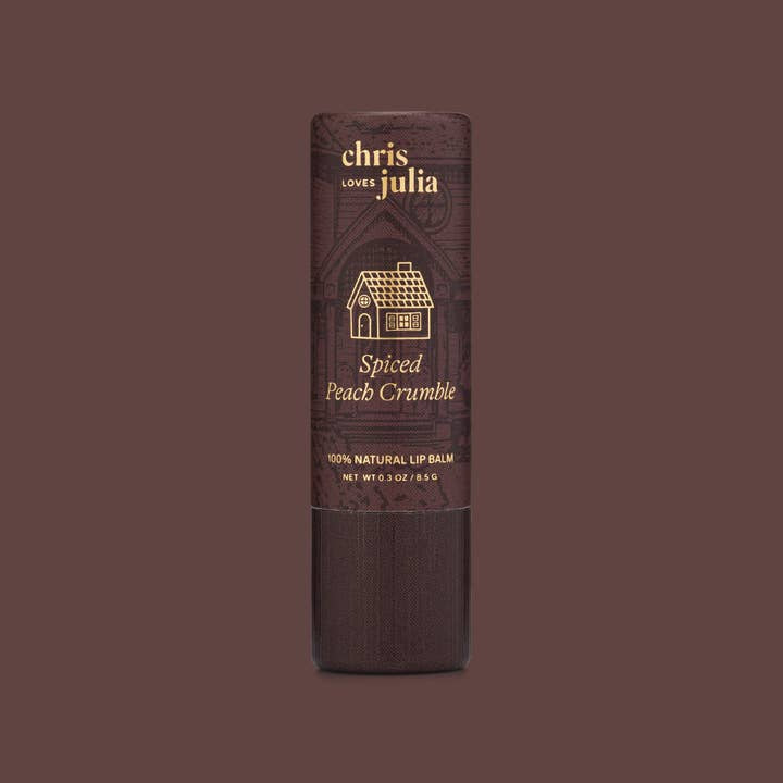 A tube of Poppy & Pout Lip Balm is shown against a matching brown background, highlighting its hand-poured, cruelty-free, and 100% natural formula.