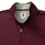 The Duck Head Long Drive Performance 1/4 Zip Pullover features a maroon color, stand collar, grey inner lining, visible neck brand tag, and moisture-wicking performance fabric for comfort and style.
