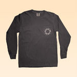 The Shop Shirt Long Sleeve | Thunderbird by Ballad of the Bird Dog is a charcoal gray tee with a chest pocket and circular white graphic/text, shown on a light beige background.