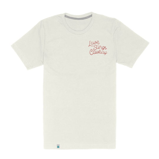 The LOVE STINGS T-SHIRT by Sendero Provisions Co. features "Love Stings Cowboy" in red script on a plain white tee—ideal for cowgirls and anyone who knows how to treat them right.