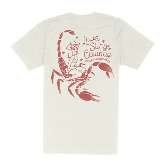 The LOVE STINGS T-SHIRT by Sendero Provisions Co. features a bold red graphic of a cowgirl on a scorpion and “Love Stings Cowboy Sendero Provisions Co” on the back—a tribute to tough cowgirls who demand respect.
