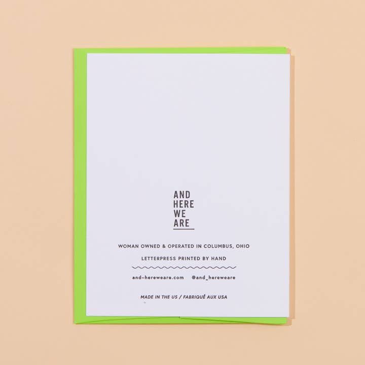 The Love you & Like you Card by And Here We Are is a white letterpress card with black text atop a green envelope. This woman-owned brand handmakes cards in Columbus, Ohio.
