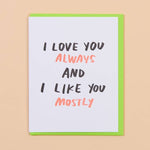 The Love you & Like you Card by And Here We Are features "I LOVE YOU ALWAYS AND I LIKE YOU MOSTLY" in bold black and red on a green envelope, making it a quirky love card for any occasion.
