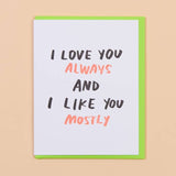 The Love you & Like you Card by And Here We Are features "I LOVE YOU ALWAYS AND I LIKE YOU MOSTLY" in bold black and red on a green envelope, making it a quirky love card for any occasion.