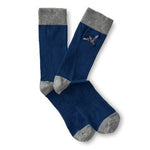 The Mallard Sock by Duck Head is a blue cotton blend pair with gray toes, heels, and cuffs, and features a small embroidered flying mallard on the side.