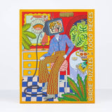 The Mama Told Me 1,000-piece puzzle by Birdie Puzzles showcases Emily M. Reay’s art—a person with a TV head amid vibrant plants and retro furniture. Made from recycled materials.