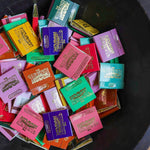 A black bowl holds assorted colorful Matches | The Incense Match by The Incense Match, each labeled with "The Strongest Match" in gold and white, creating a unique incense gift.