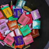 A black bowl holds assorted colorful Matches | The Incense Match by The Incense Match, each labeled with "The Strongest Match" in gold and white, creating a unique incense gift.