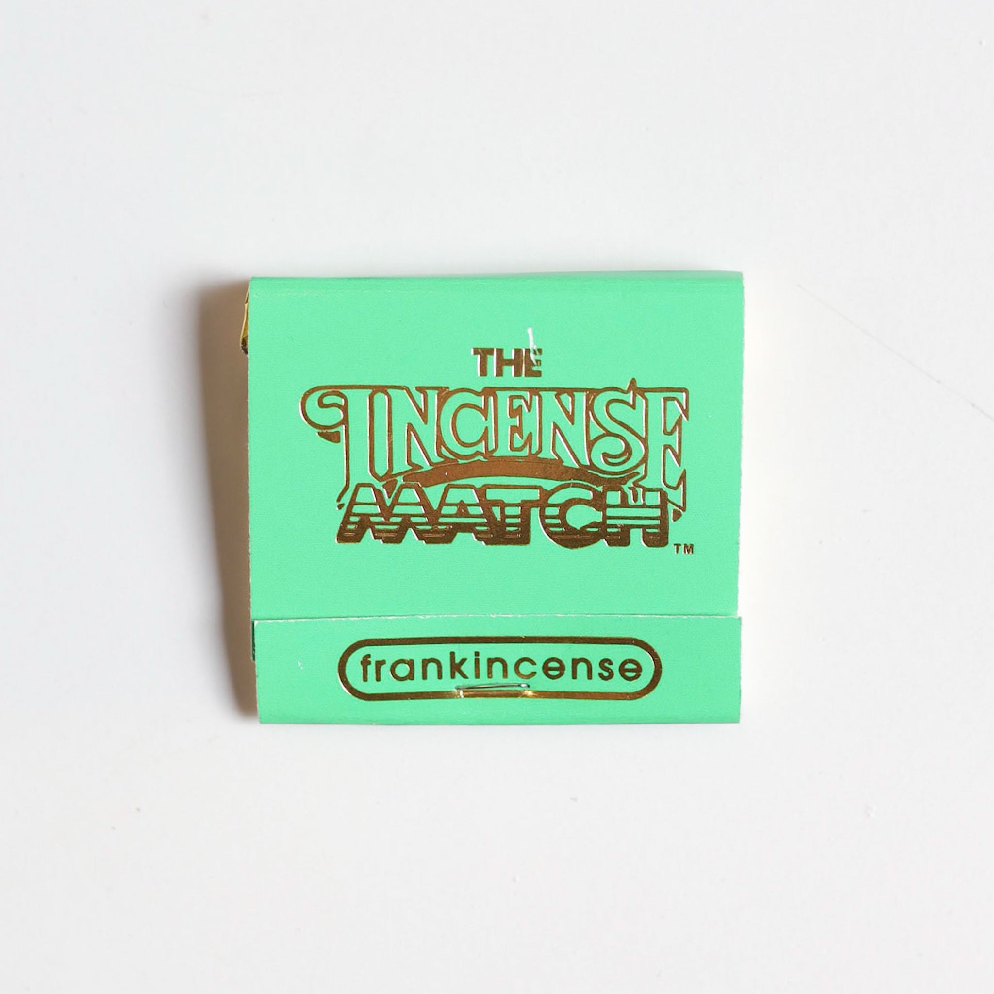 A green matchbook labeled "Matches | The Incense Match" by The Incense Match, featuring a frankincense scent—ideal as an incense gift or air freshener—displayed on a plain white background.