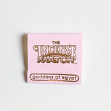 A pink booklet labeled "Matches | The Incense Match" by The Incense Match, featuring "goddess of egypt" at the bottom, is shown on a white background. This unique product works as both incense matches and an air freshener.