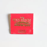 A red "Matches | The Incense Match" matchbook by The Incense Match with "Spice" in gold on the front, ideal as an incense gift or air freshener, displayed on a plain white background.