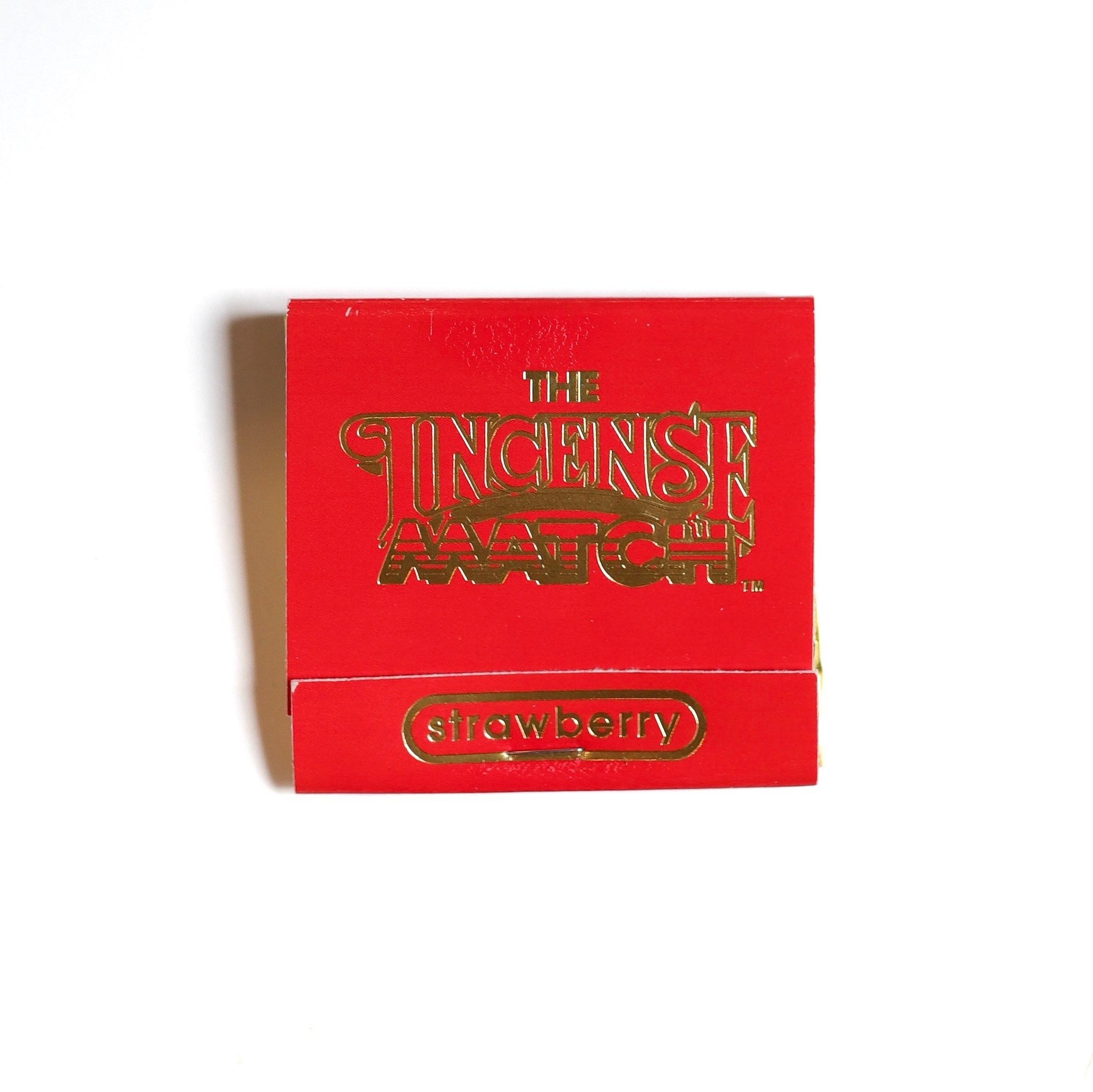 A red packet labeled "Matches | The Incense Match" by The Incense Match, featuring "strawberry" in gold text, is shown on a white background—an ideal incense gift or portable air freshener solution.