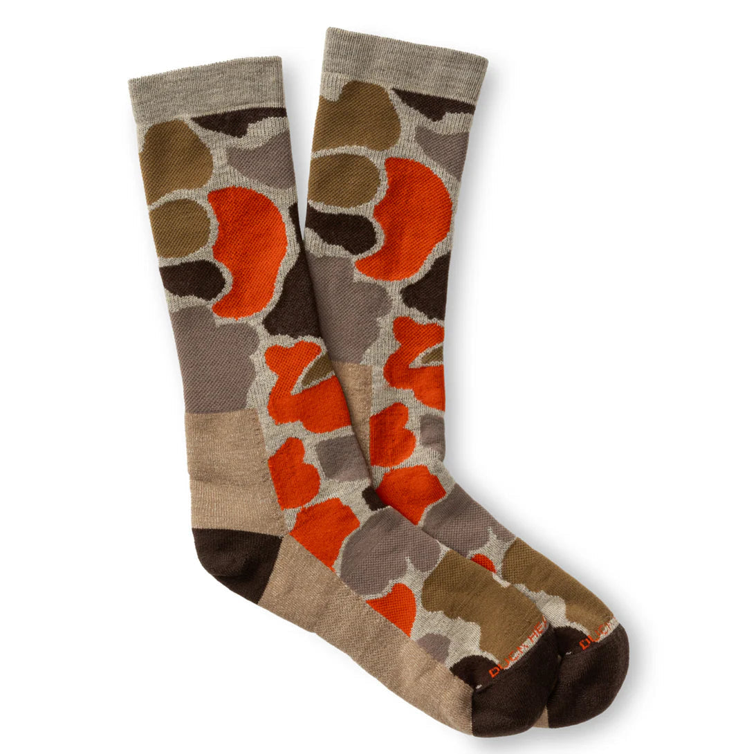 The Duck Head Merino Wool Sock is a crew-length pair with an abstract brown, orange, and beige pattern on a neutral background.