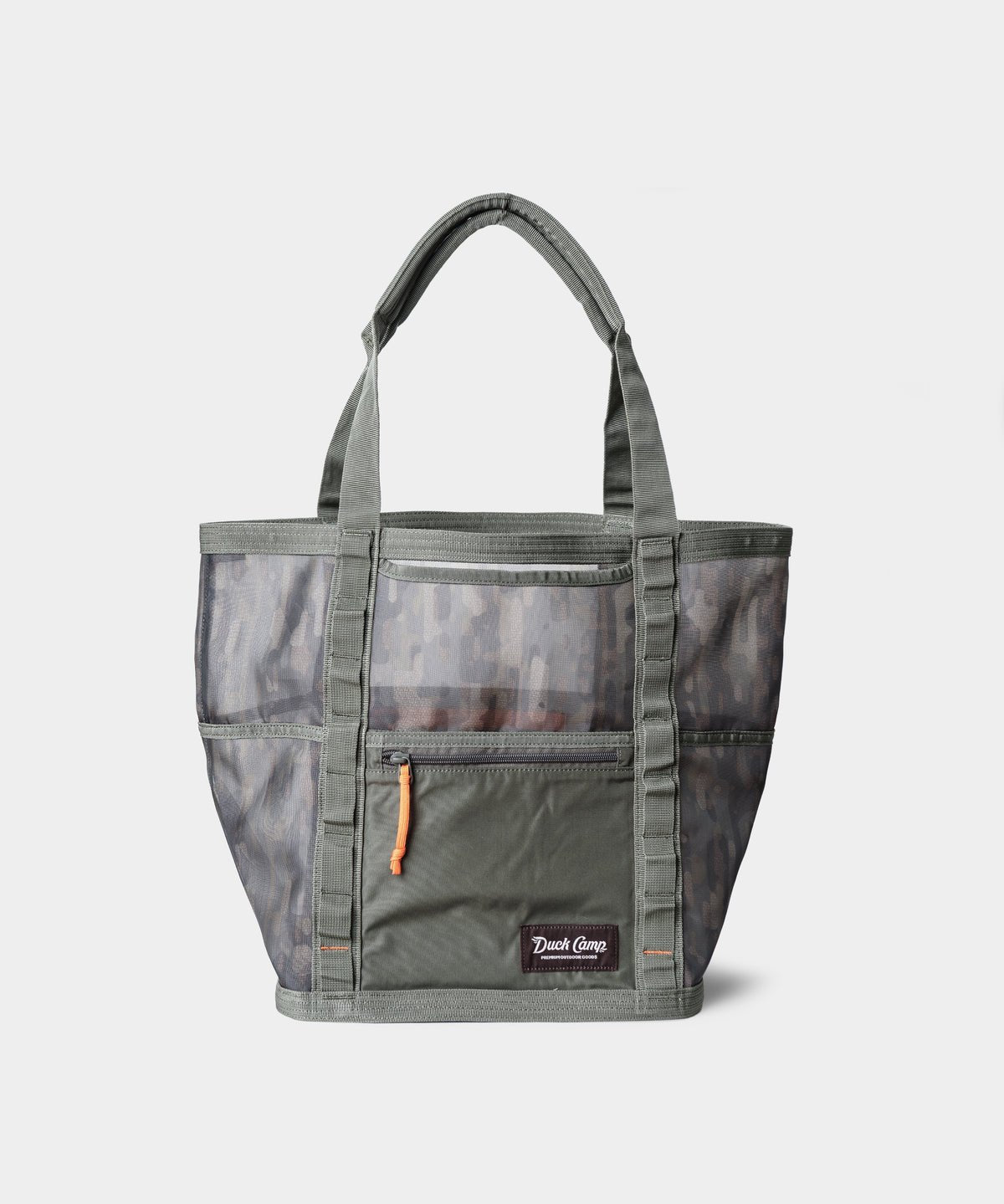 The Duck Camp Mesh Gear Tote is a gray and olive green heavy-duty bag with a camouflage pattern, front zipper pocket with orange pull, dual handles, and water-resistant mesh. Shown against a plain white background.