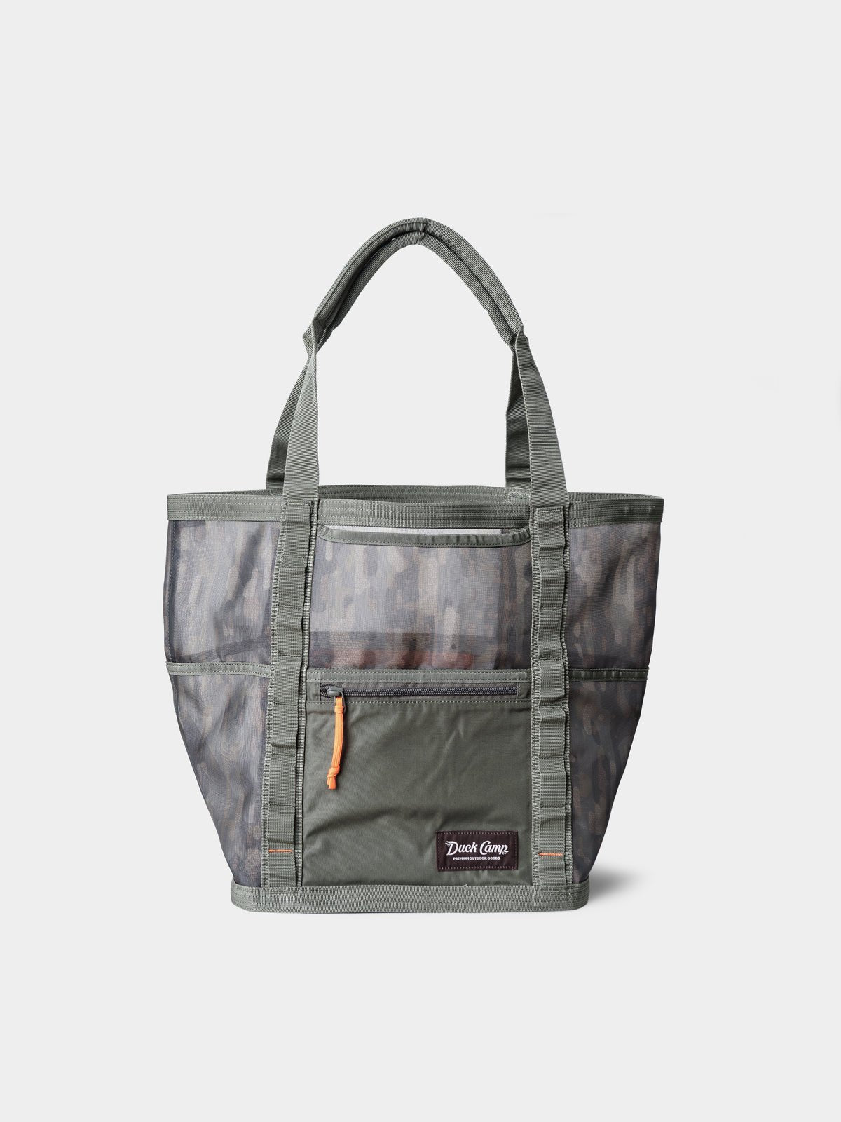 The Duck Camp Mesh Gear Tote is a gray and olive green heavy-duty bag with a camouflage pattern, front zipper pocket with orange pull, dual handles, and water-resistant mesh. Shown against a plain white background.