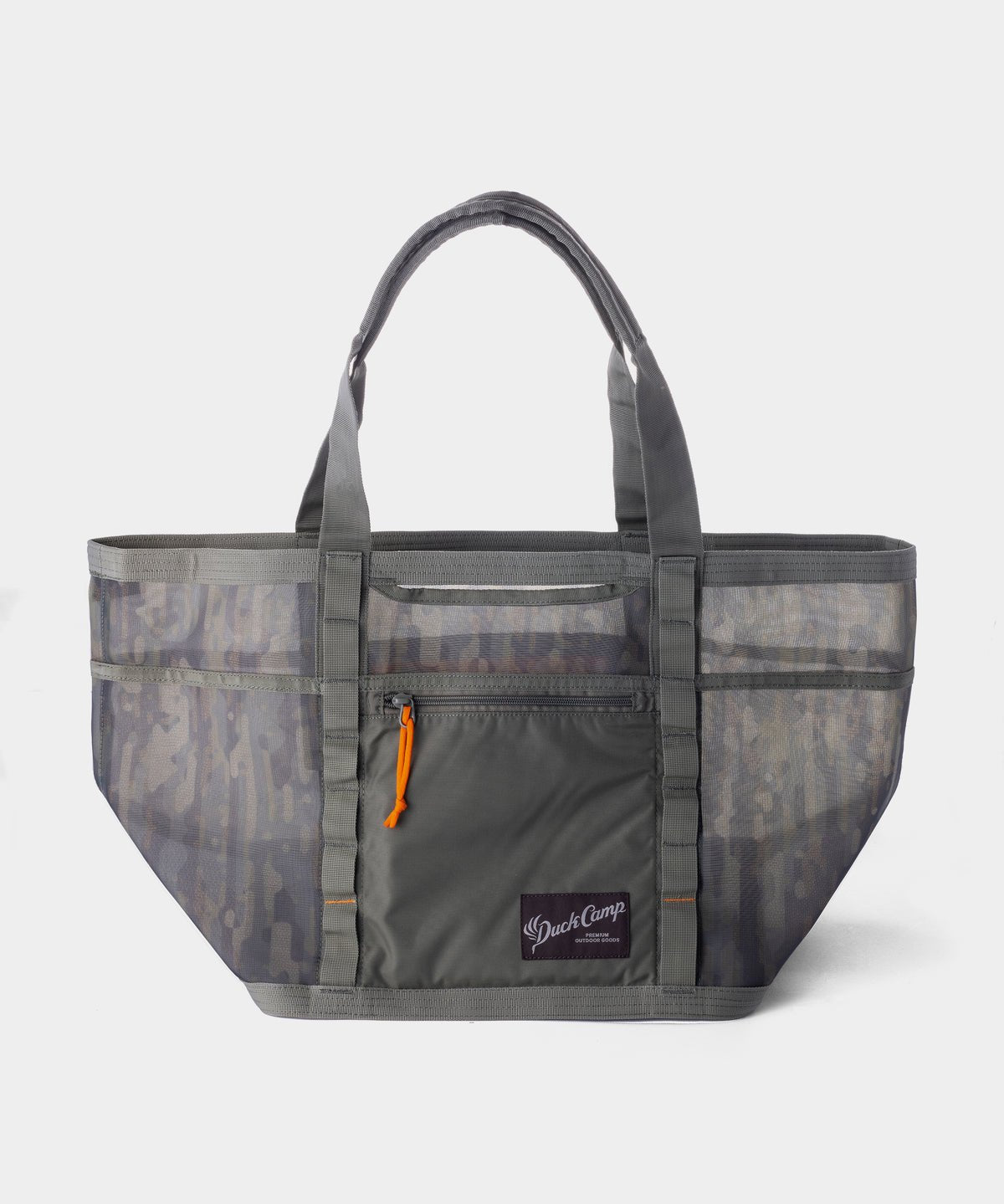 The Duck Camp Mesh Gear Tote is a large, gray heavy-duty bag with breathable mesh side panels, a front zip pocket with an orange zipper pull, dual handles, and a branded logo patch on the front.