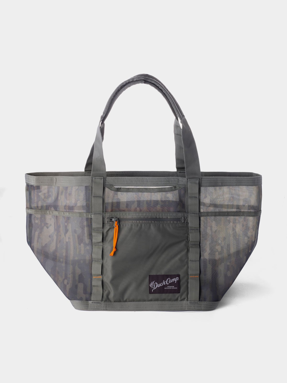 The Duck Camp Mesh Gear Tote is a large, gray heavy-duty bag with breathable mesh side panels, a front zip pocket with an orange zipper pull, dual handles, and a branded logo patch on the front.