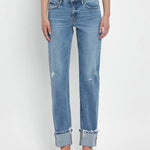 Someone styles the Vervet Mid Rise Cuffed Straight Jean—a light blue comfort stretch denim with frayed cuffs and slight distressing—with a white top and open-toe heels.