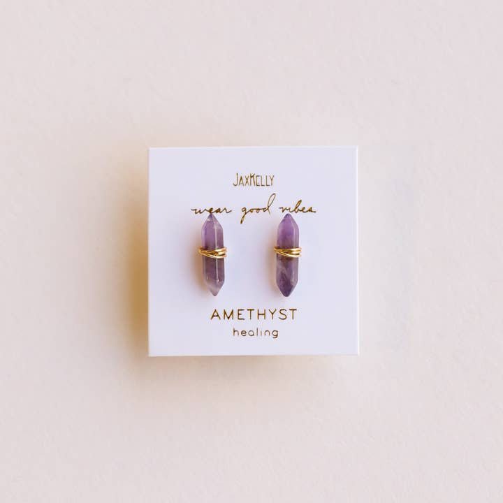 Mineral Point Amethyst Gold stud earrings by JaxKelly: amethyst crystals wrapped in gold wire on a card with "Amethyst healing" and "wear good vibes." Crafted with gold-plated sterling silver—hypoallergenic and stylish.