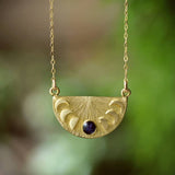 The cameoko Moon Phase Pendant Necklace features engraved lunar phases and a small crushed gem accent on a gold vermeil chain.