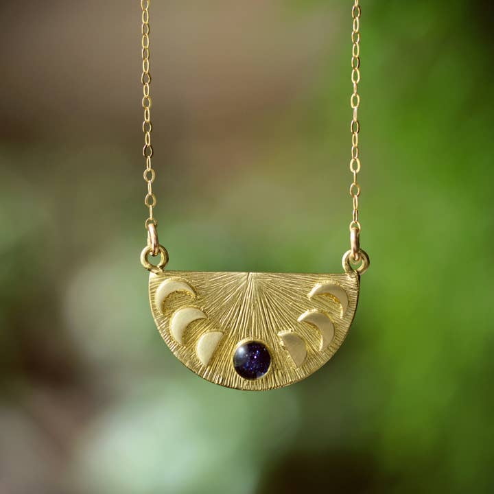 The cameoko Moon Phase Pendant Necklace features engraved lunar phases and a small crushed gem accent on a gold vermeil chain.