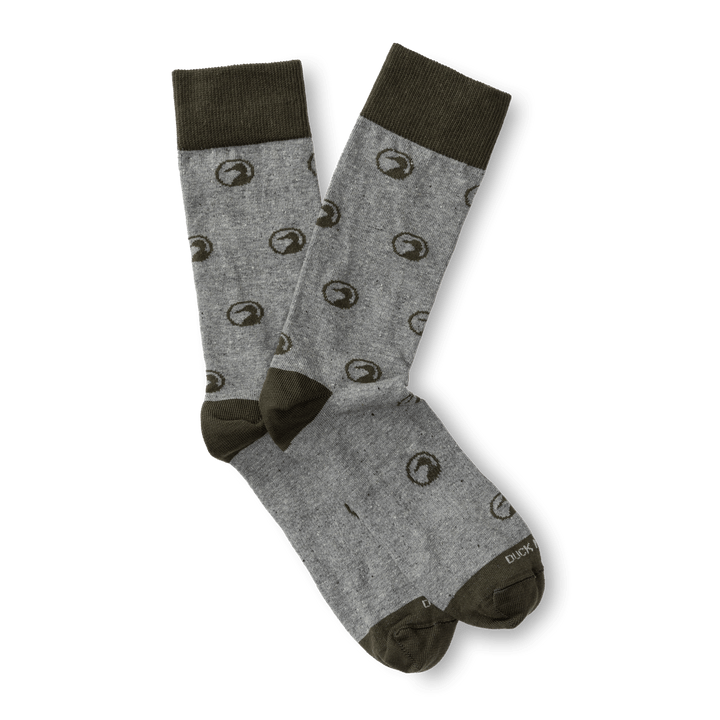 Duck Head Motif Socks: Gray socks with a repeating circular design, accented by dark green toe, heel, and cuffs. Made in the USA by Duck Head.