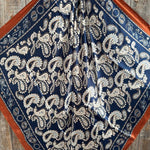 The Rodeo Drive Navy and Rust Floral Paisley Wild Rag features a stylish paisley print with a rust border—ideal as a western scarf or wild rag.