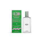 A clear glass perfume bottle labeled "No.11 Eau de Parfum | Blomb" with a silver cap stands next to a green box featuring white and pink text highlighting its long-lasting scent and natural aroma.