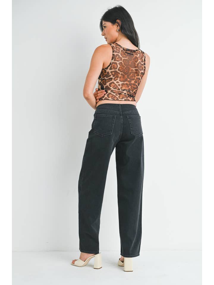 A woman stands facing away, wearing a sleeveless leopard print top, JBD No Waistband Low Rise Straight | Just Black Denim jeans with a 30" inseam, and white heeled sandals against a plain white background.