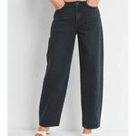 Person wears JBD's No Waistband Low Rise Straight jeans by Just Black Denim, paired with a leopard print crop top and cream heeled sandals, standing against a white background.