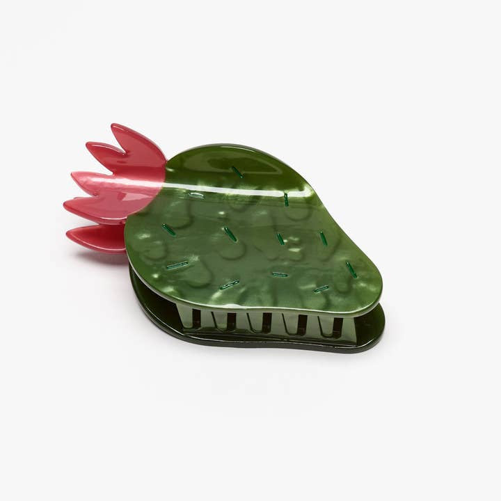 The Nopal Succulent Cactus Hair Claw Clip by Winona Irene features a green cactus design with pink leaves, made from cellulose acetate and shown on a white background.