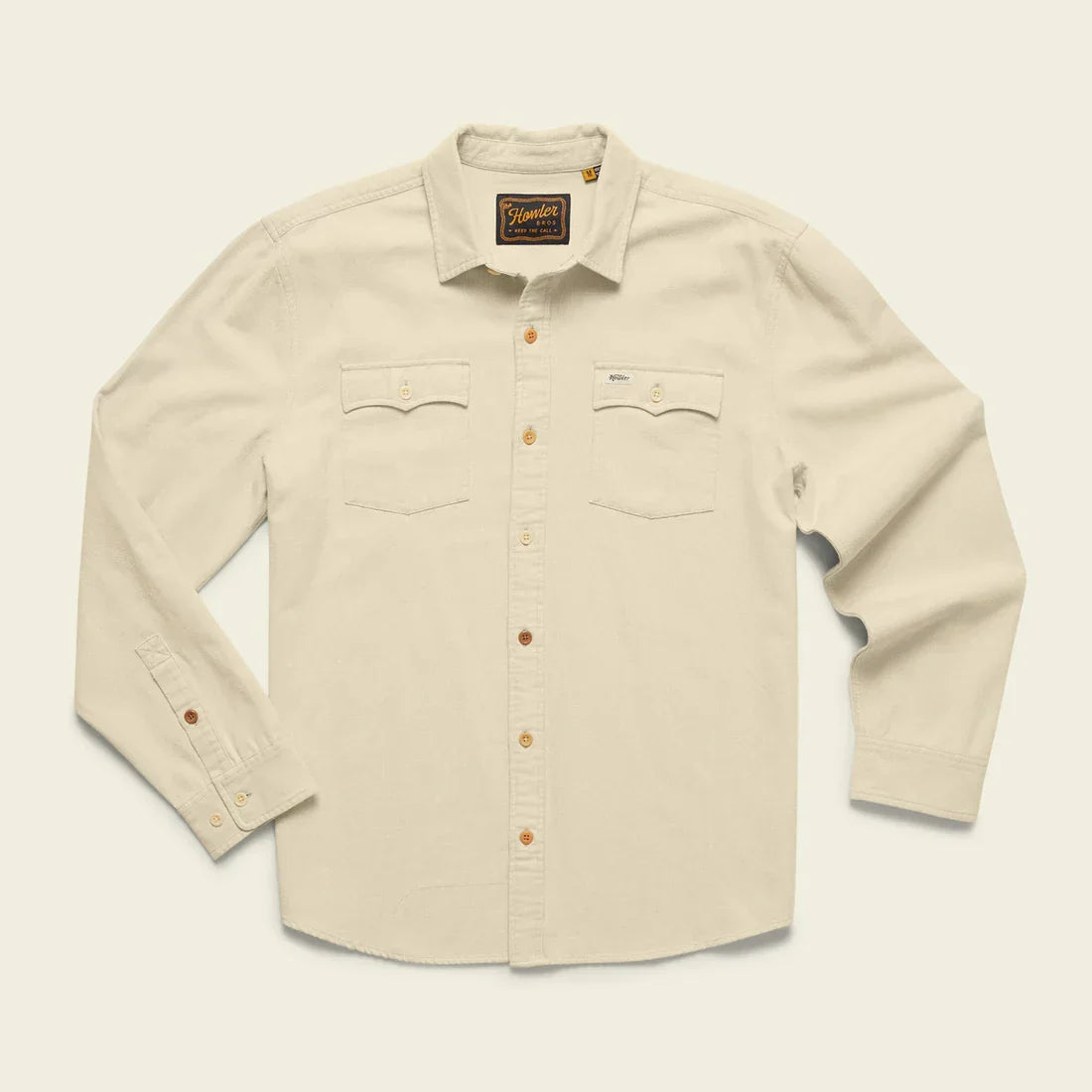 The Novato Shirt by Howler Brothers is a cream-colored, long-sleeve vintage western shirt in enzyme-washed sashiko dobby cotton with two chest pockets and brown buttons, shown laid flat on a neutral background.