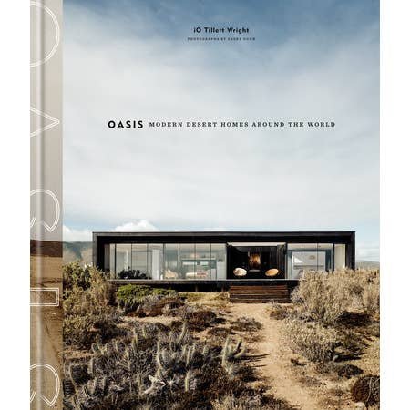Book cover for "Oasis | Penguin" by Penguin, showcasing a sleek black desert home with expansive windows amidst arid vegetation and a clear blue sky.