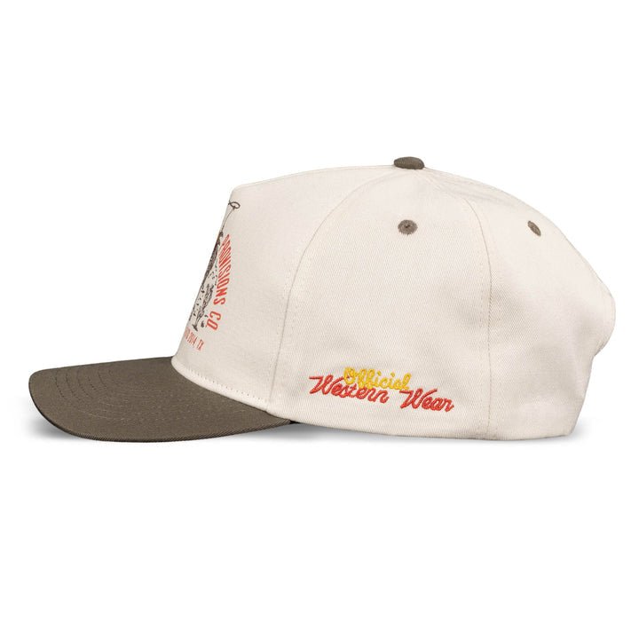 The Official Western Hat by Sendero Provisions Co. is a cream cap with a brown brim, featuring "Official Western Wear" embroidered in yellow and red on the side—a classic western-inspired style.