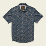 The Howler Brothers Open Country Tech Shirt in Rancher Floral features short sleeves, a dark blue floral print, two buttoned chest pockets, quick-dry fabric, and UPF 35 sun protection.