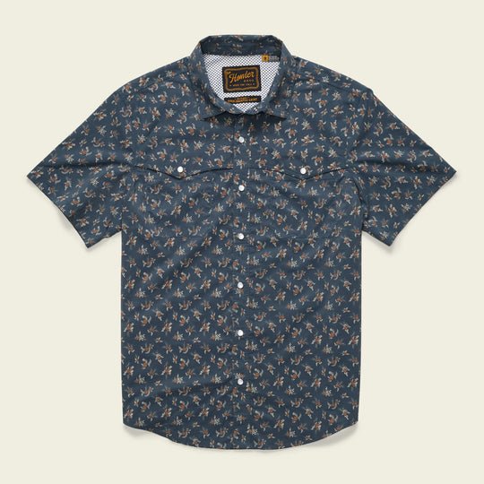 The Howler Brothers Open Country Tech Shirt in Rancher Floral features short sleeves, a dark blue floral print, two buttoned chest pockets, quick-dry fabric, and UPF 35 sun protection.